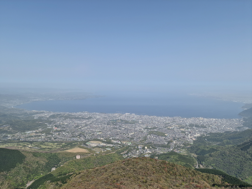 Beppu is following the sea shore in a large open valley