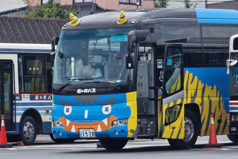 A bus painted with the face of an angry blue devil