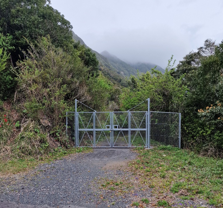 A metal gate closing the road ahead