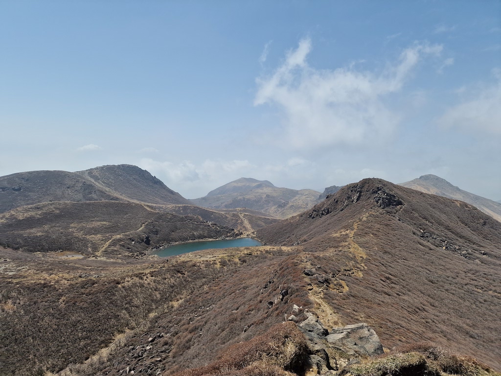 Peaks surrounding a small blue lake