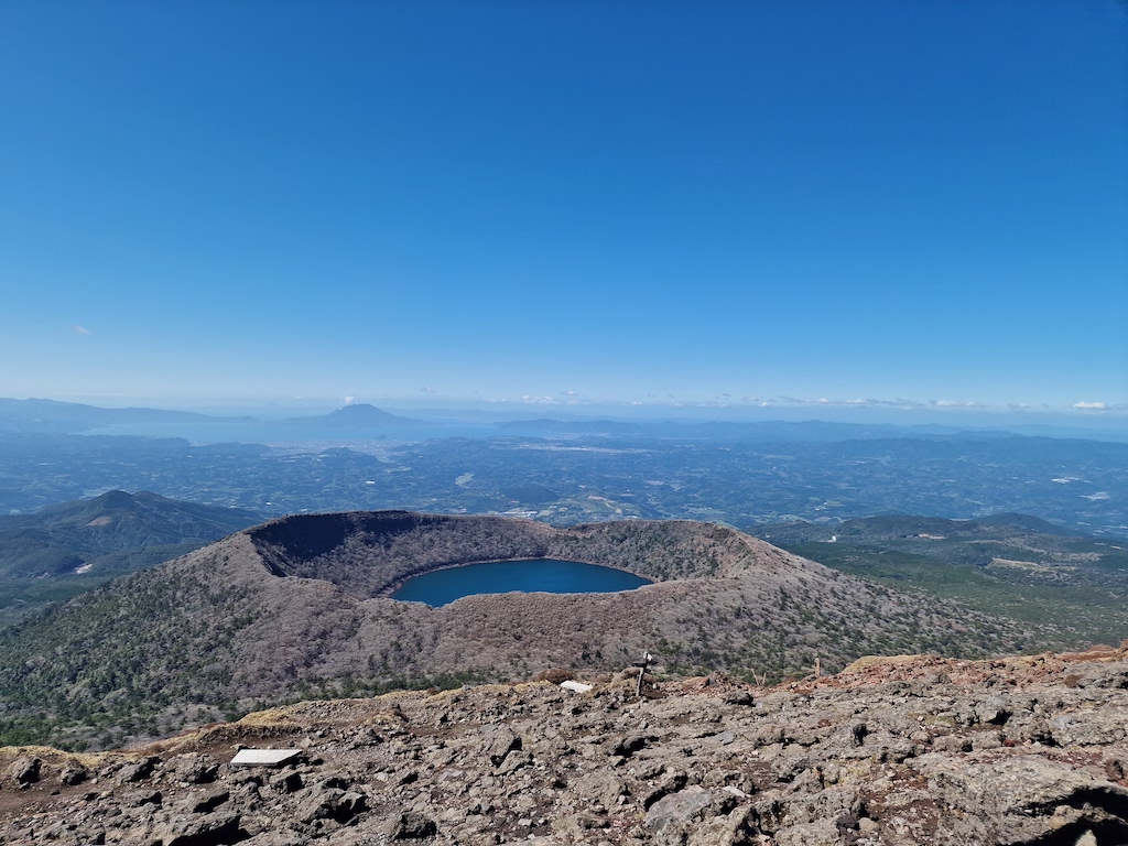 A blue lake inside a volcano crater