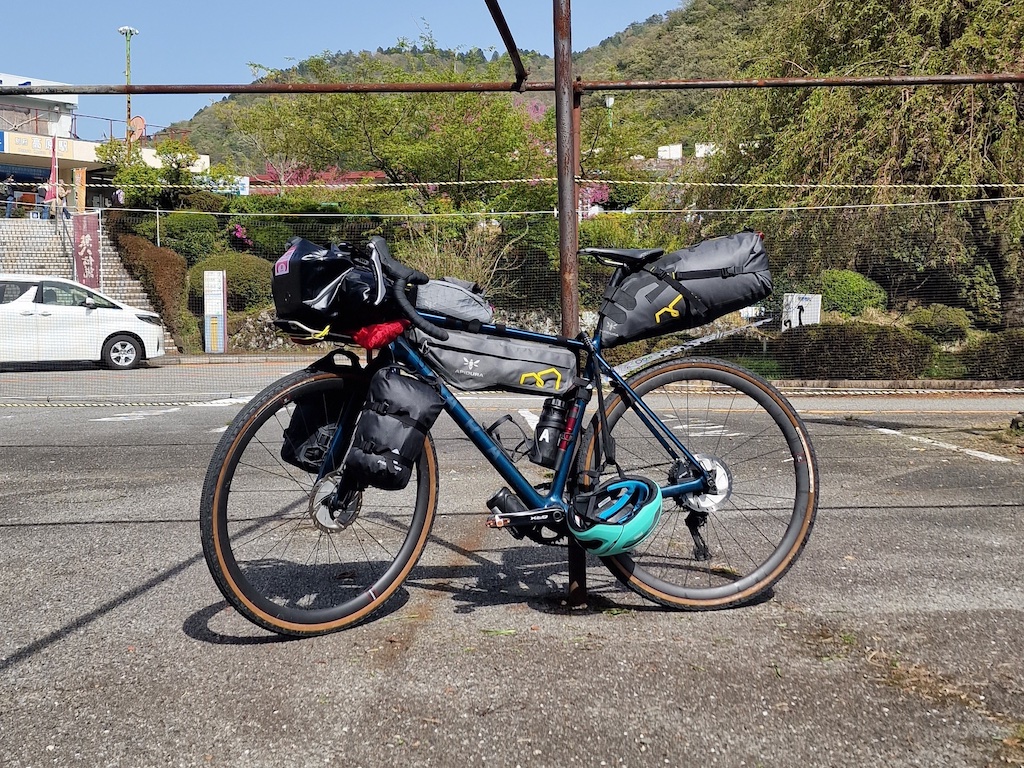 A gravel bike leaning on a metal pole