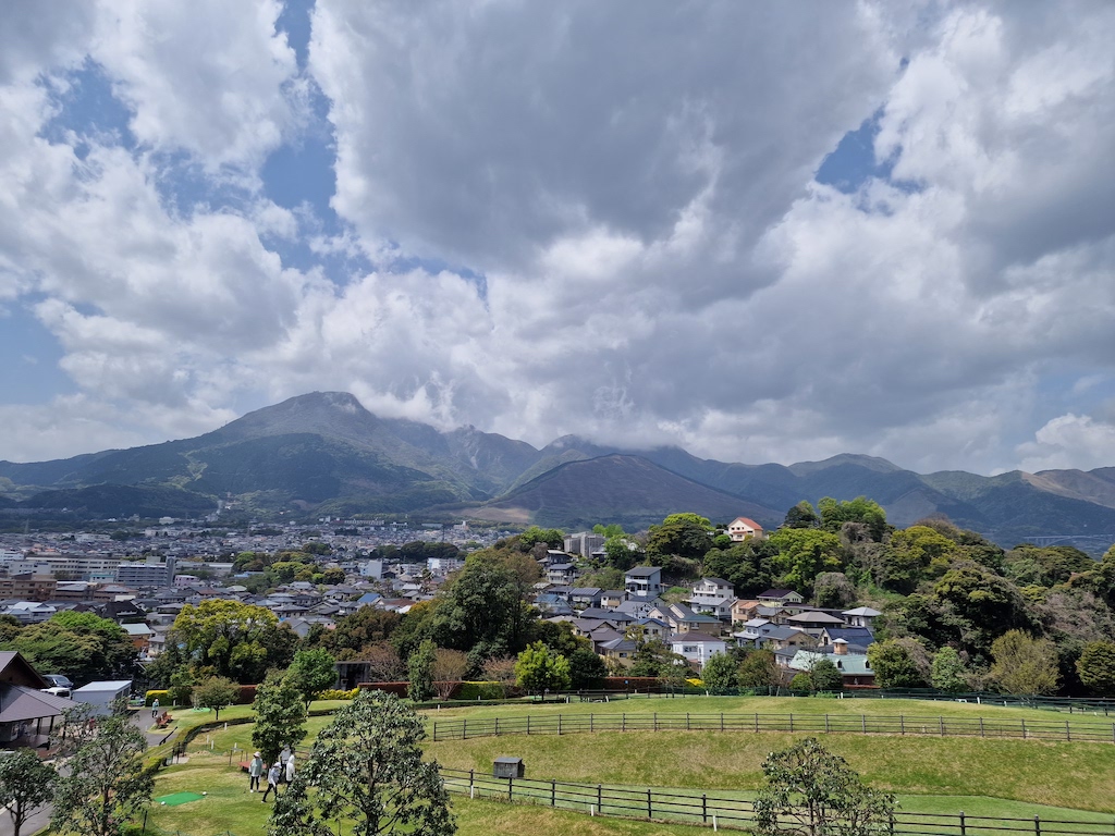 The park golf course next to a neighborhood with big mountains in the background