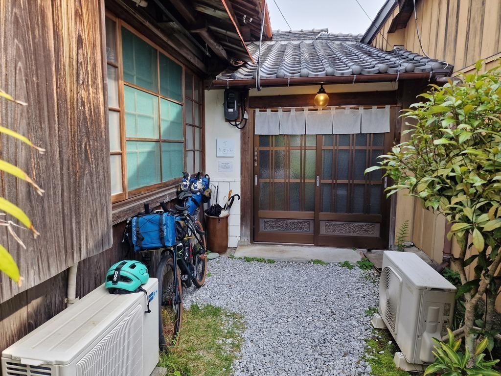 My bike outside the entrance to a hostel in an old family house