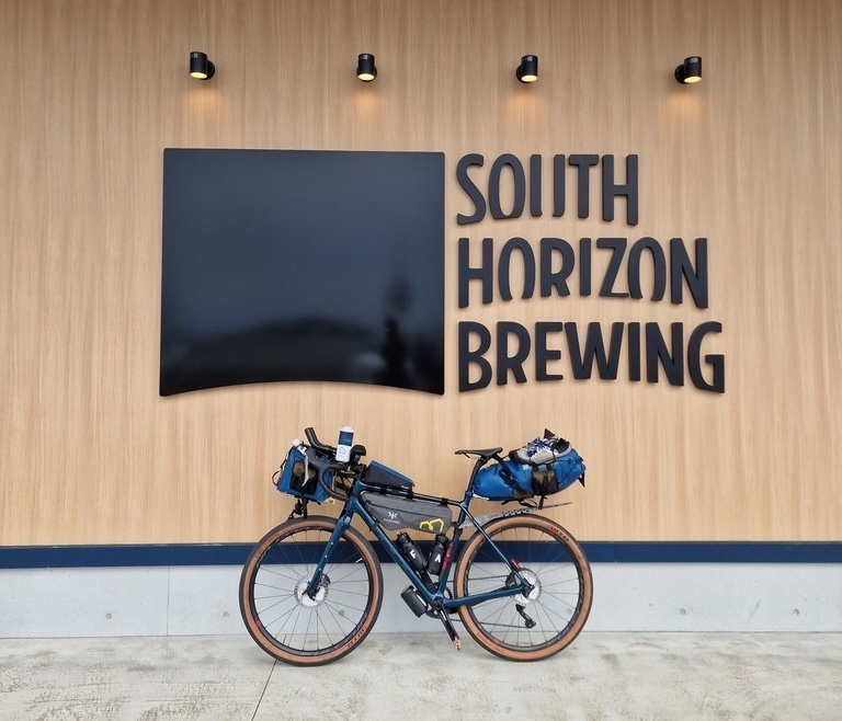 A wooden wall, with South Horizon Brewing written in big black letters