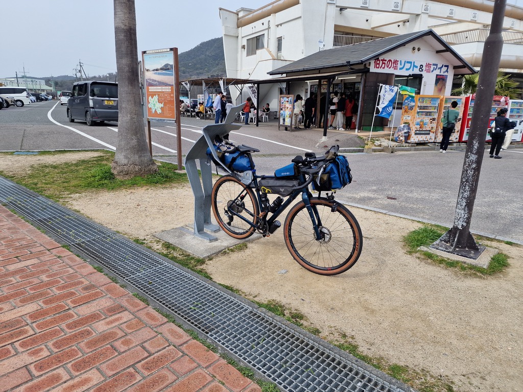 ANOTHER human shaped bike stand, this one bending over while holding your bike.