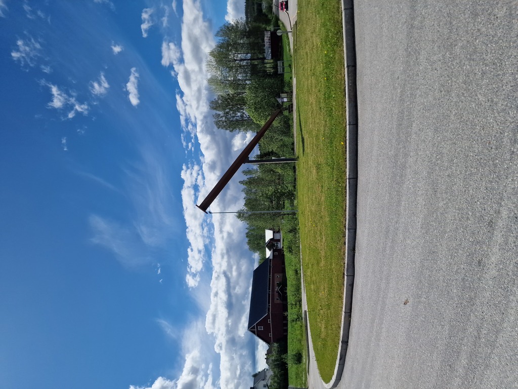 A big sculptor of a wood nail in a roundabout.